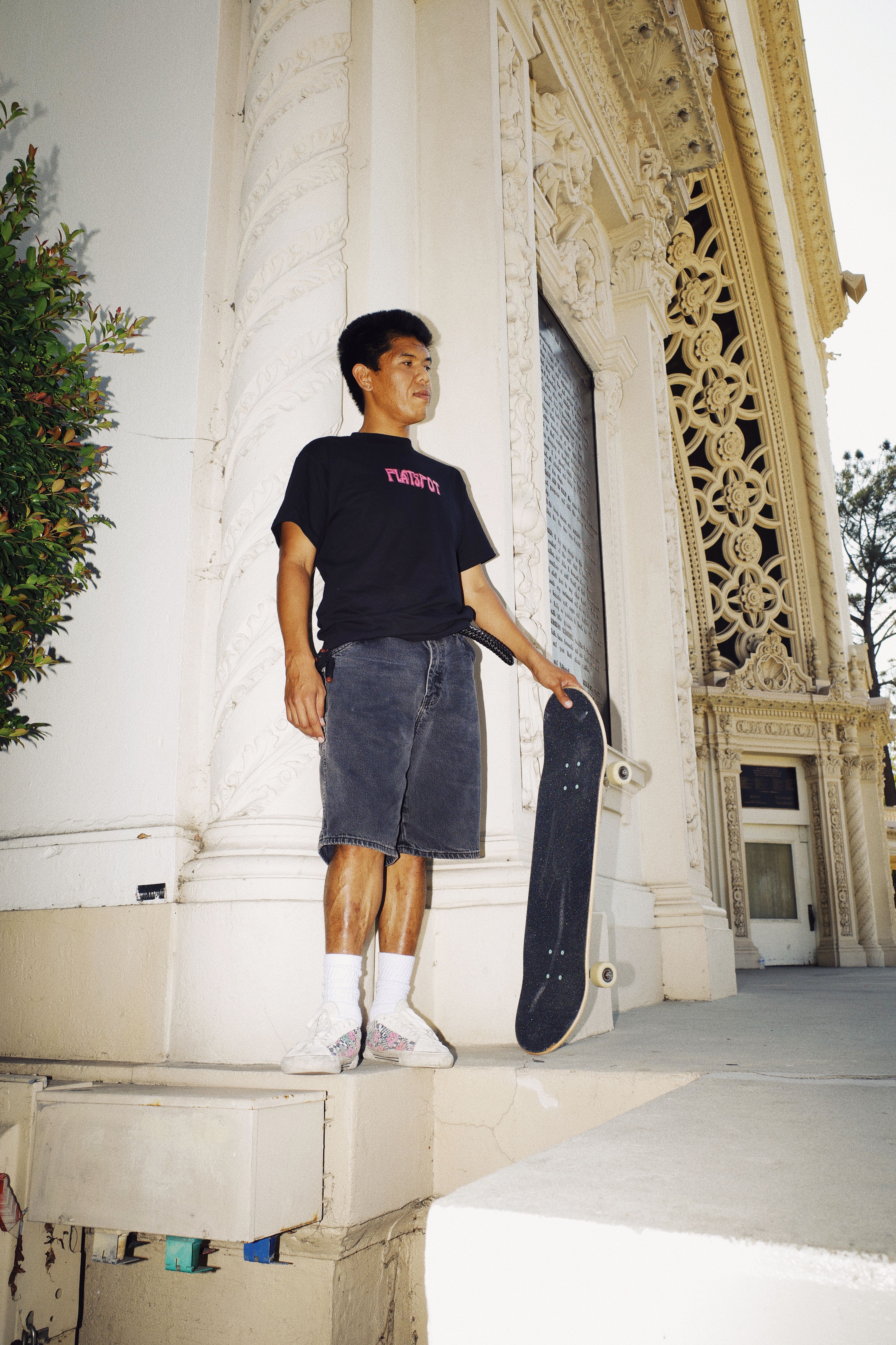 Flatspot AW21 Collection skater poised in black graphic tee
